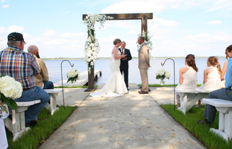 couple reading wedding vows by the sea